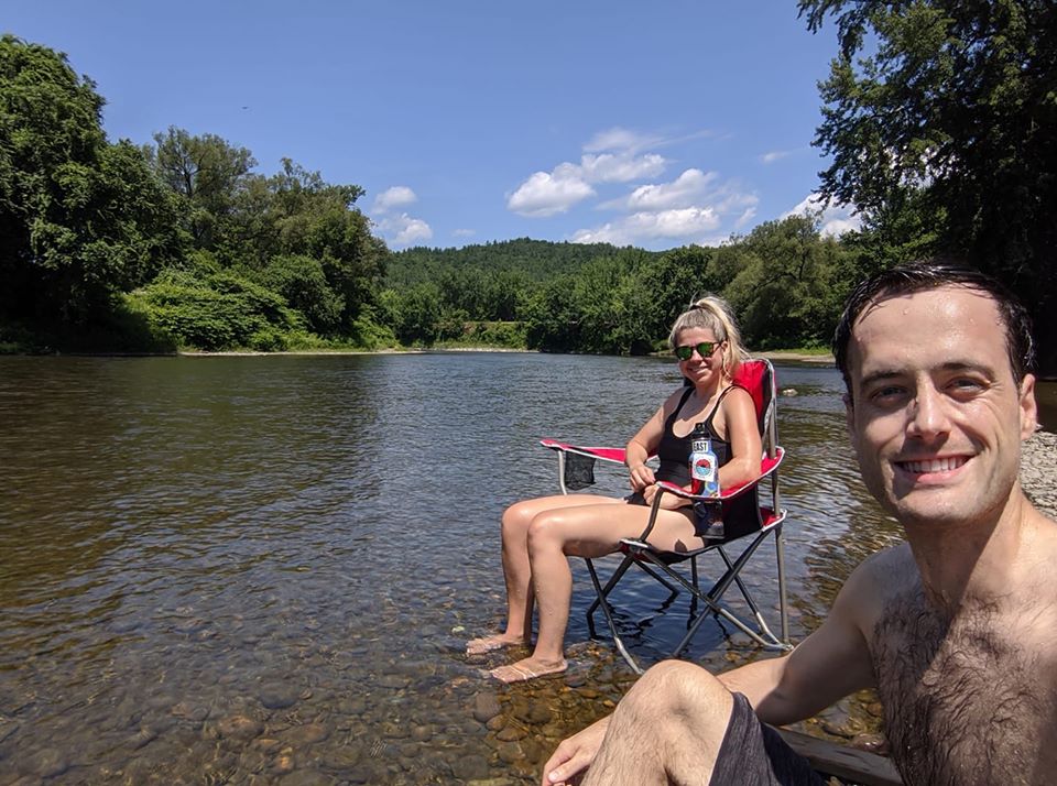 Individuals enjoying the Winooski River on a summer day