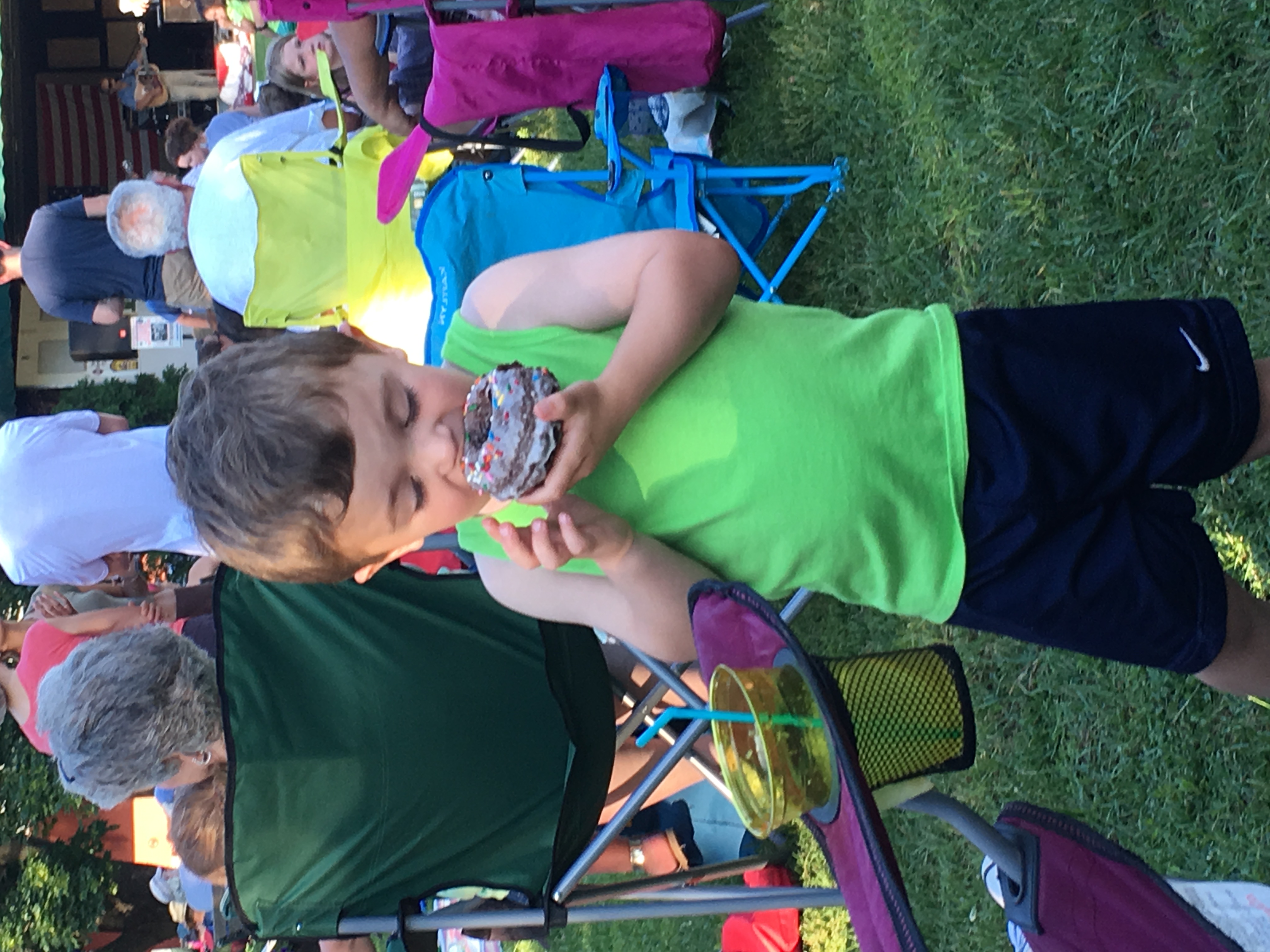 Happy kid eating a donut at the Waterbury Farmers Market, photo by Waterbury Farmers Market