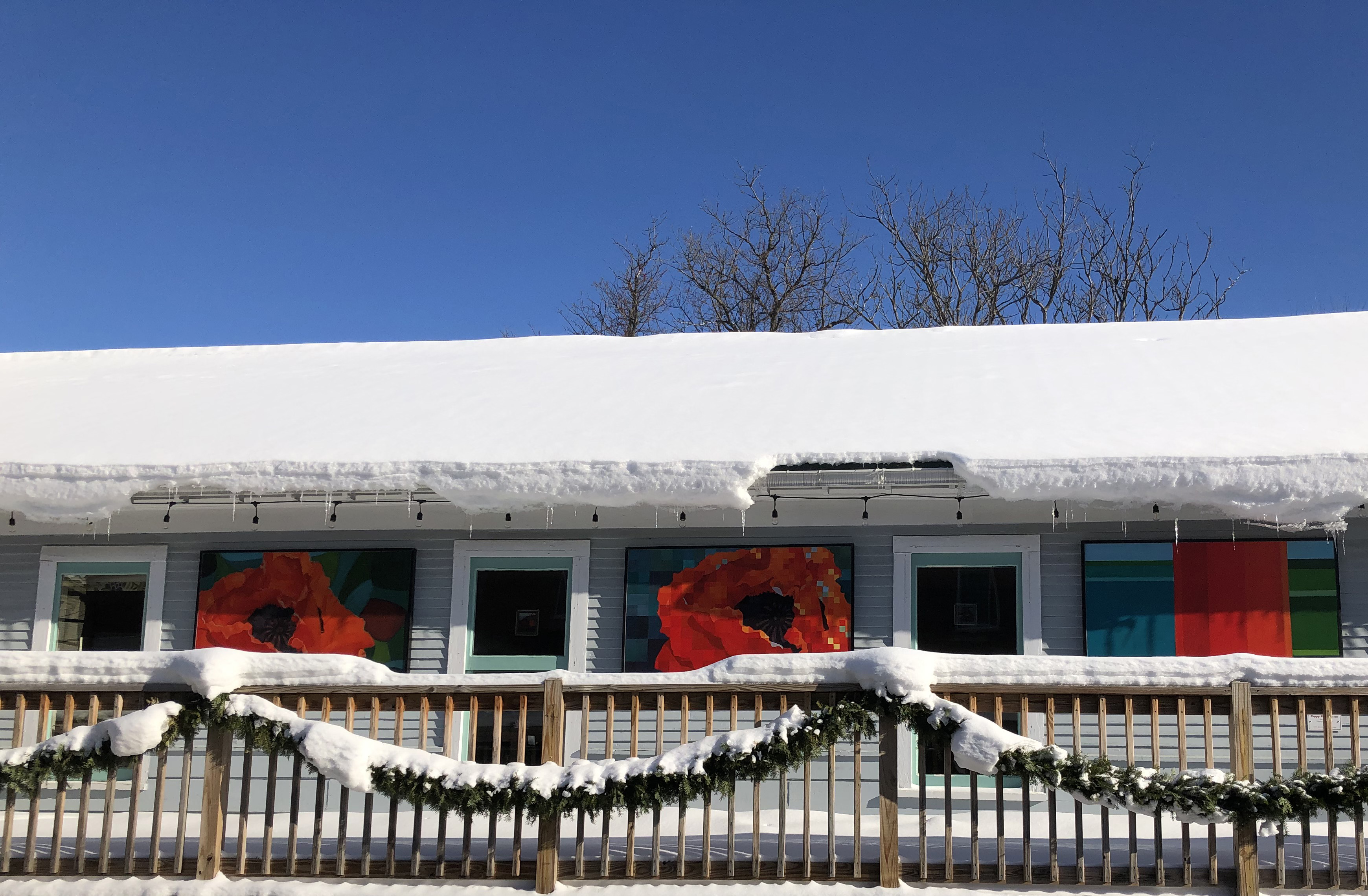 Colorful triptych by Torrey Carroll Smith outside of Stowe Street Cafe