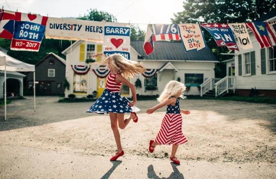 Two kids dancing and wearing patriotic outfits