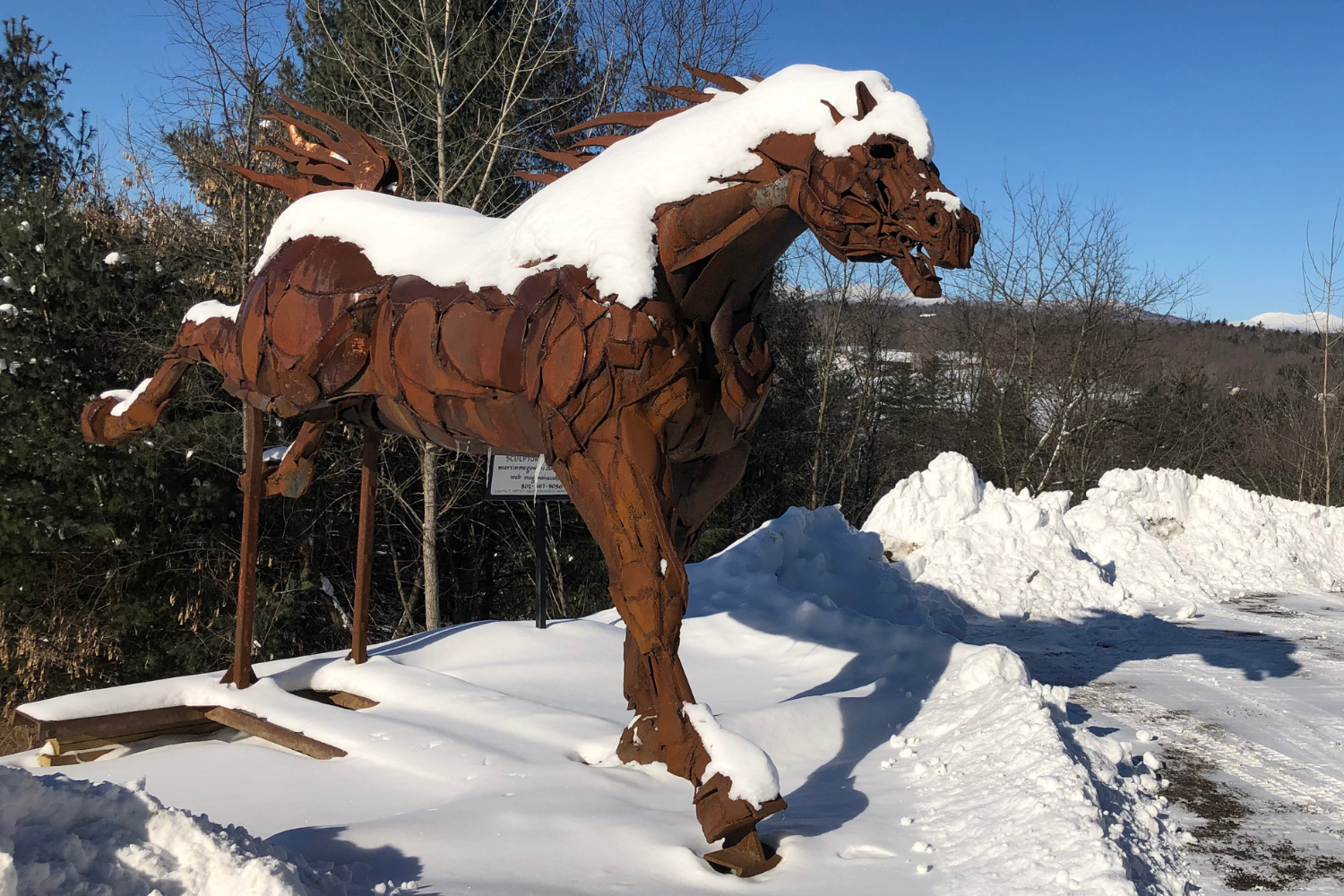 A sculpture of a horse in the snow